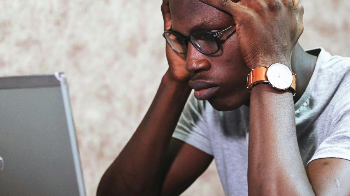 A stressed-looking man looking at his computer